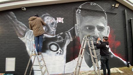 Artists working on the Ben Youngs mural at Holt Rugby Football Club.