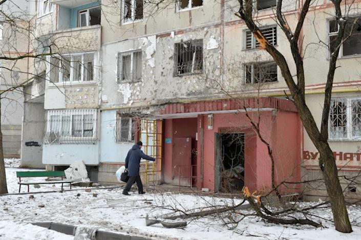 A view of a residential building damaged by recent shelling in Kharkiv on Feb. 26, 2022. - Russia ordered its troops to advance in Ukraine "from all directions" as the Ukrainian capital Kyiv imposed a blanket curfew and officials reported 198 civilian deaths.