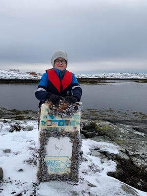 Karel Nuncic, a sixth-grade student in Norway, seen with the recovered Rye Riptides miniature boat which was set to sea in October 2020.