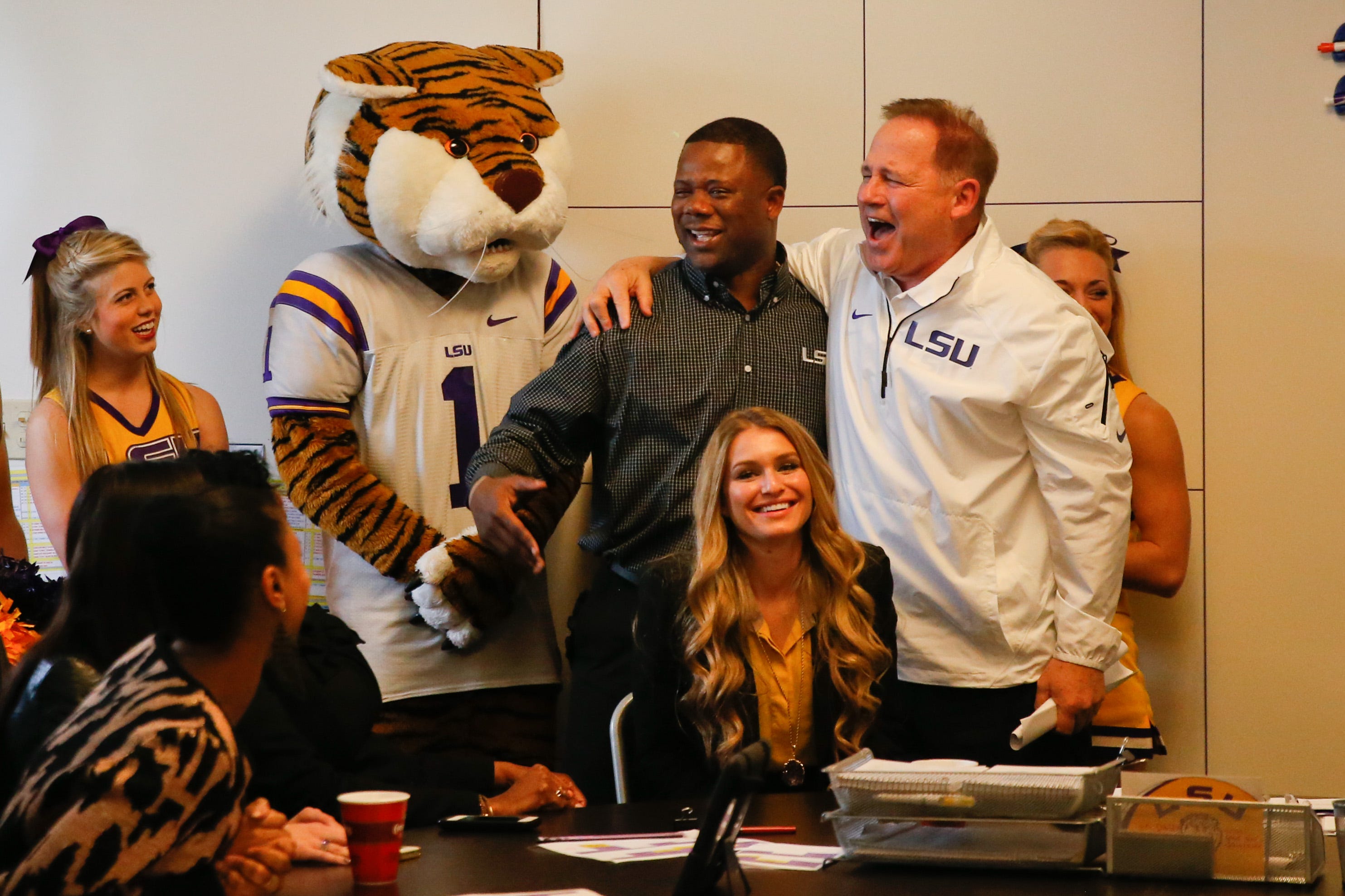 LSU's then-head football coach Les Miles alongside Tigers recruitment coordinator and running back coach Frank Wilson (middle).