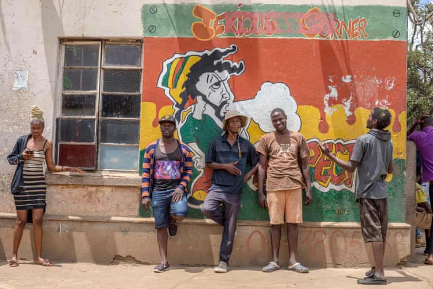 Matsika, with Chimweta and friends, in front of a mural he painted.