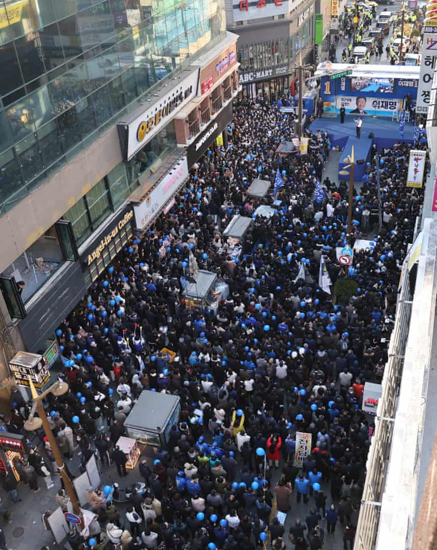 Voters gather to listen to a speech by Lee Jae-myung during his campaign stop in the south-eastern port city of Busan.