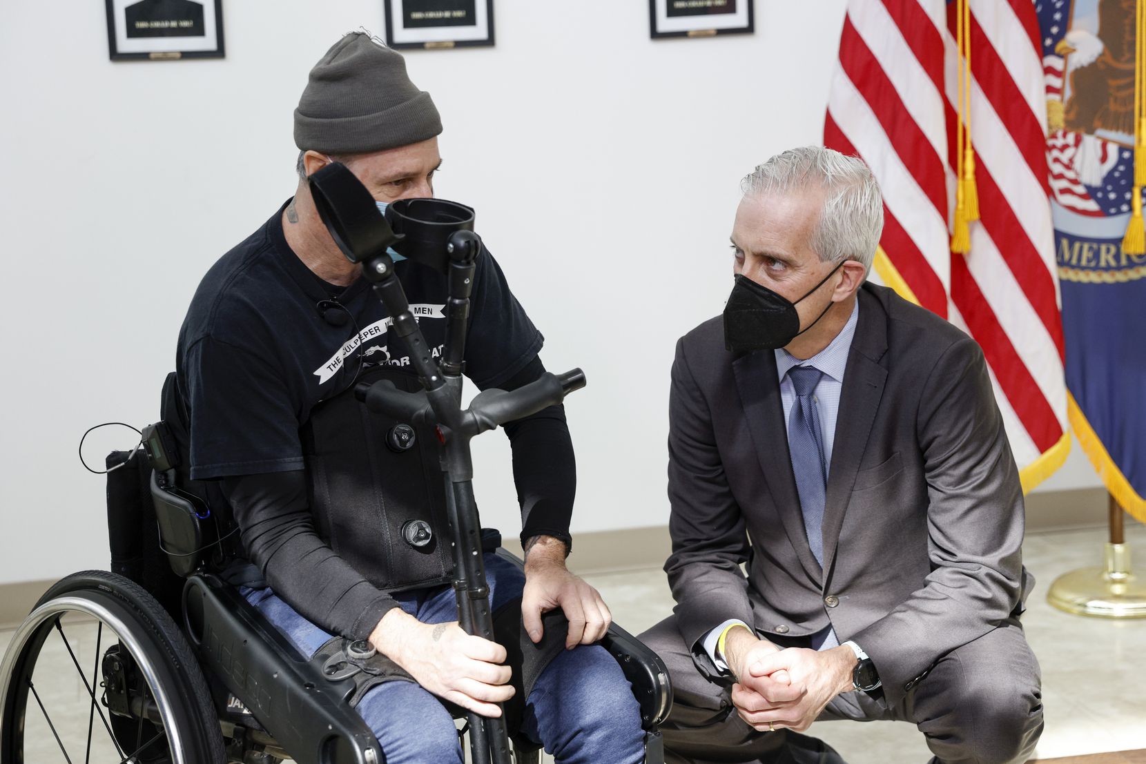 Army veteran John Caruso (left) speaks with Veterans Secretary Denis McDonough before a...