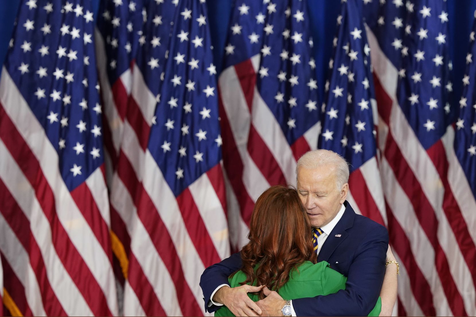 President Joe Biden hugs U.S. Army veteran Elizabeth Beck after she introduced him at the...