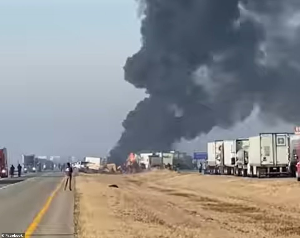 Smoke billowing from vehicles on I-57 following a fatal pile-up involving at least 40 cars
