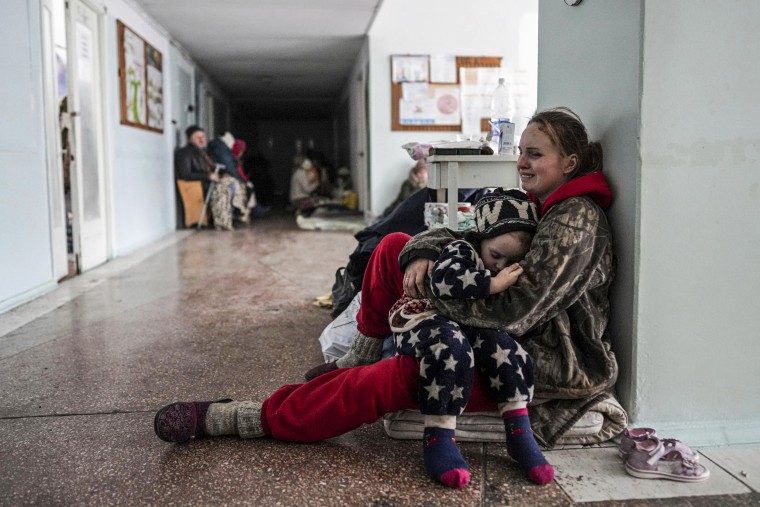 Anastasia Erashova cries as she hugs her child in a corridor of a hospital in Mariupol, Ukraine.  on March 11, 2022. Anastasia's other child was killed during shelling in Mariupol.