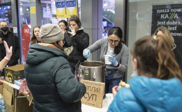 A group of Ukrainian refugees receive food in Poland. 