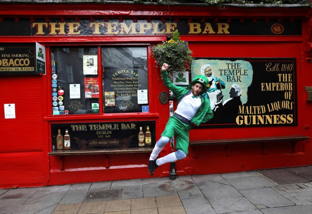 A tourist dressed up for St Patrick's Day outside Temple Bar in Dublin city centre, Ireland on March 17, 2020. AP file photo - 