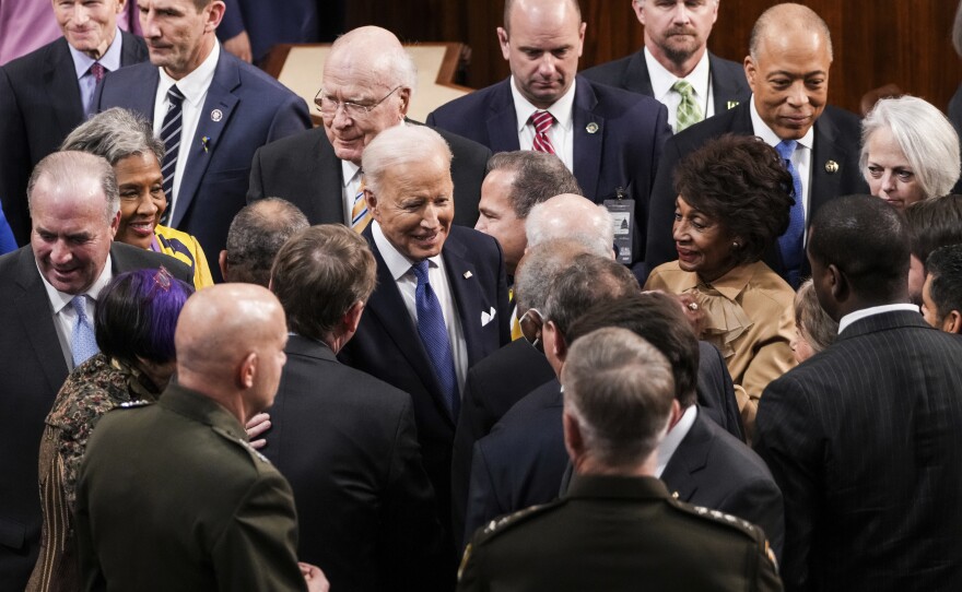 President Biden talks to lawmakers after delivering his State of the Union address on Tuesday.