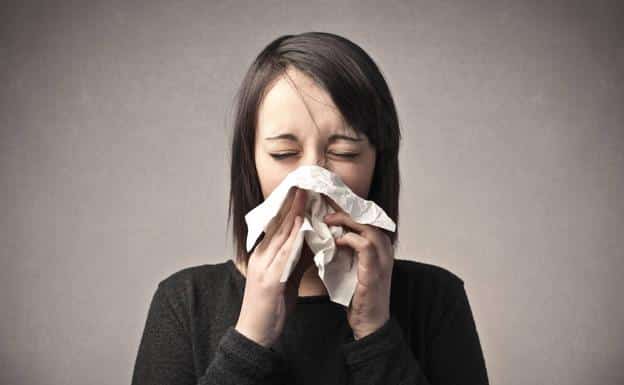 A woman shows symptom of spring allergy.