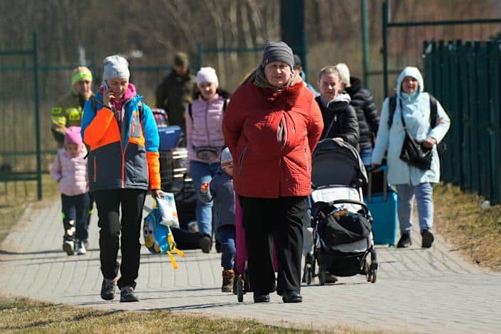 Refugees walk at the border crossing in Medyka, southeastern Poland, after fleeing the war in Ukraine on March 27, 2022.