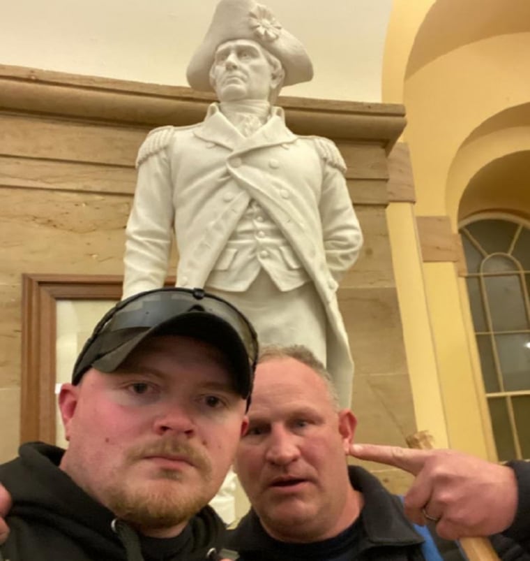 Jacob Fracker, left, and Thomas Robertson at the Capitol Building on Jan. 6, 2021, in front of a statute of John Stark.