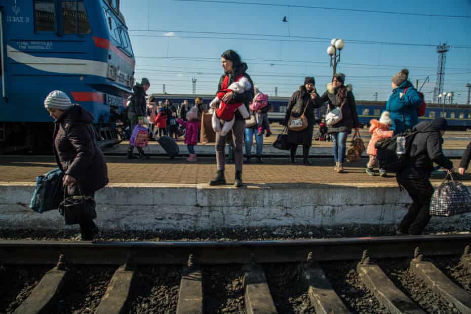 Ukrainians at Lviv railway station try to catch an evacuation train to Poland.
