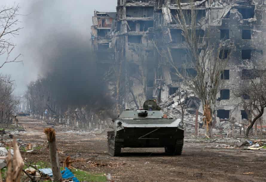 Pro-Russian troops ride an armored vehicle during fighting near the Azovstal factory in Mariupol