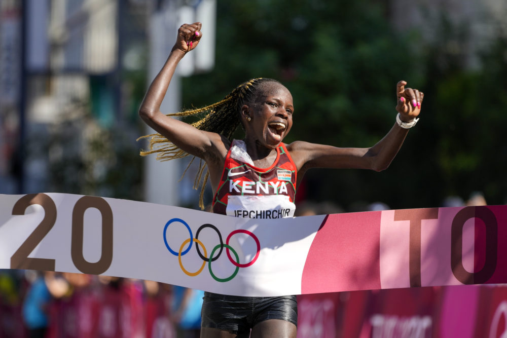 Peres Jepchirchir, of Kenya, celebrates as she crosses the finish line to win the women's marathon at the 2020 Summer Olympics on Aug. 7, 2021, in Sapporo, Japan. (Eugene Hoshiko/AP)