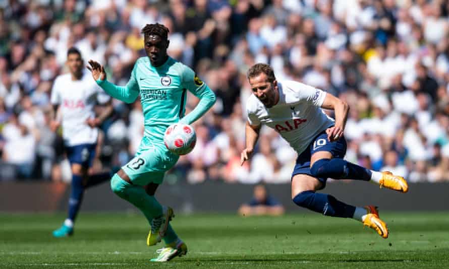 Harry Kane goes down after a challenge from Yves Bissouma in Spurs' home defeat to Brighton.