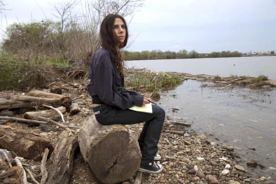 Pj Harvey sits on a riverbank in A Dog Called Money, the film she made with Seamus Murphy in 2019
