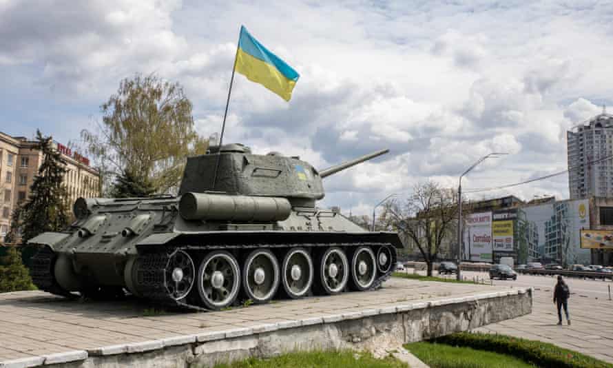 A Soviet monument to the tank divisions that fought against Nazi Germany is adorned with a Ukrainian flag