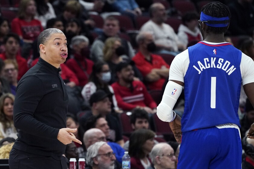Clippers coach Tyronn Lue talks to guard Reggie Jackson during the first half.