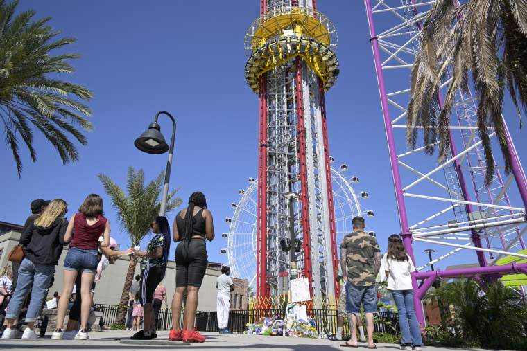 People visit a makeshift memorial for Tyre Sampson outside the Orlando Free Fall ride at ICON Park on March 27, 2022, in Orlando, Fla. Sampson, a teenager visiting from Missouri on spring break, fell to his death while on the ride.