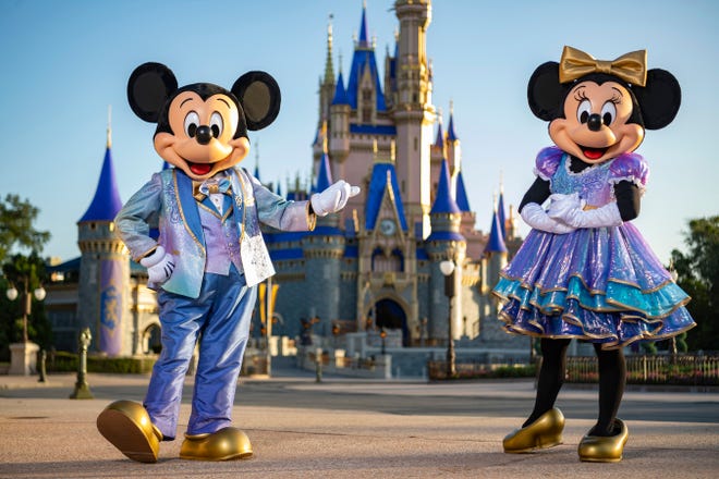 Iconic Disney characters Mickey Mouse and Minnie Mouse pictured during Walt Disney World Resort’s 50th anniversary celebration in Lake Buena Vista, Fla. The company running the world famous park has drawn fire from Florida Gov. Ron DeSantis for opposing what has become known as 
