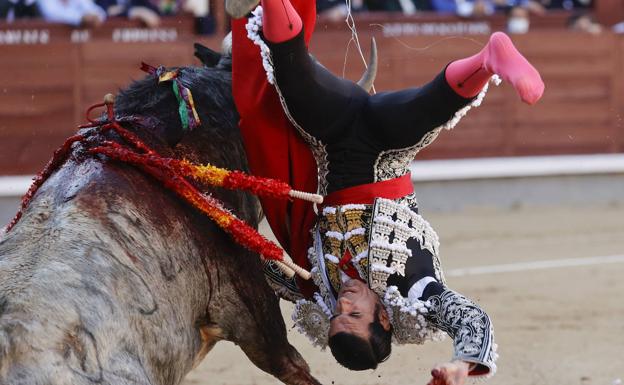 Emilio de Justo is caught by the bull during the Palm Sunday bullfight at the Las Ventas bullring in Madrid.
