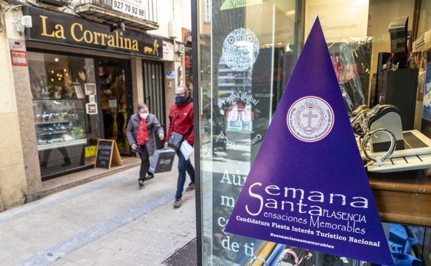 Purple triangles already decorate shops and homes in the city.
