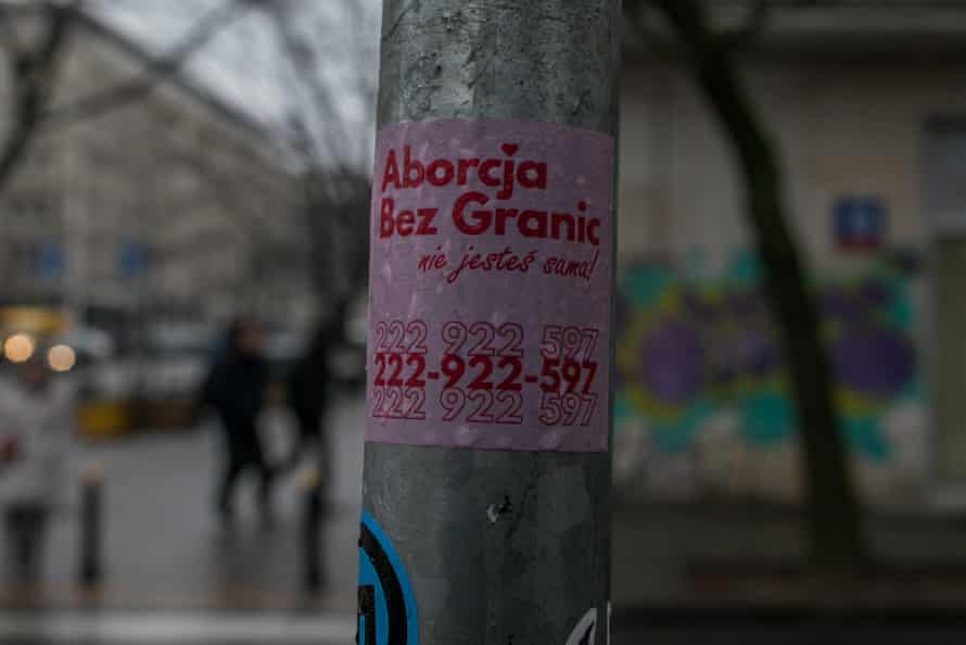 A sticker on a pole with writing in Polish