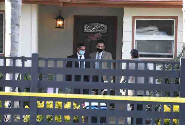LA police investigate the scene where three children were found...