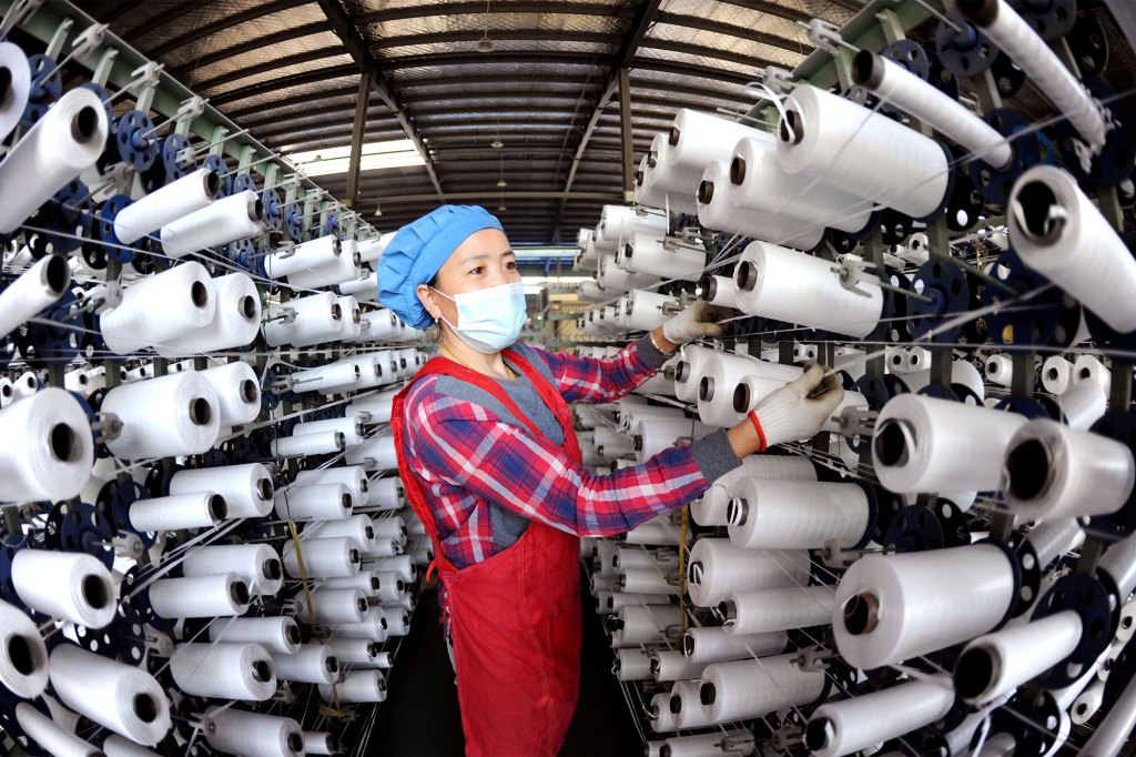 A worker works on a production line at a woven bag manufacturer in Lianyungang city, East China's Jiangsu Province, May 5, 2022.