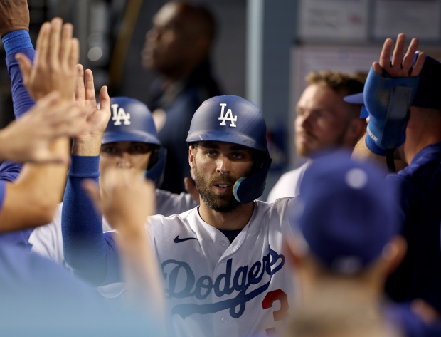The Dodgers’ Chris Taylor, ahead of Austin Barnes, celebrate in...