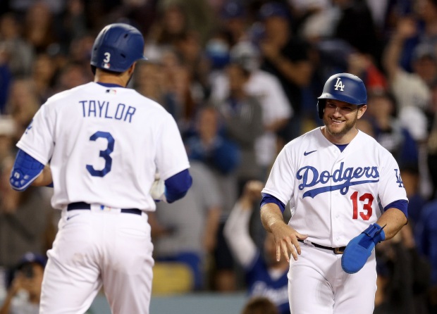 The Dodgers’ Max Muncy, right, waits to celebrate with Chris...