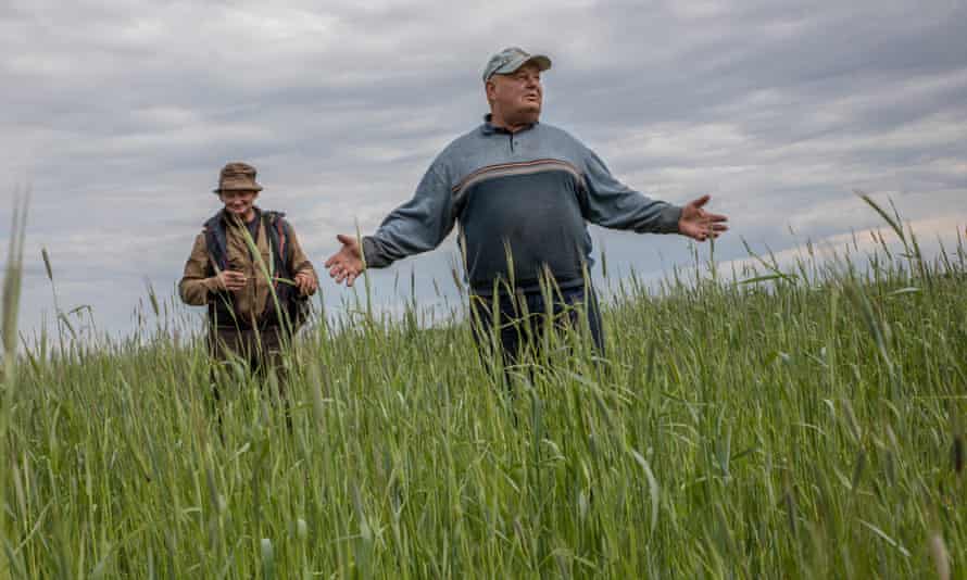 Ivan and his son, Roman, in the wheatfield close to their farm.