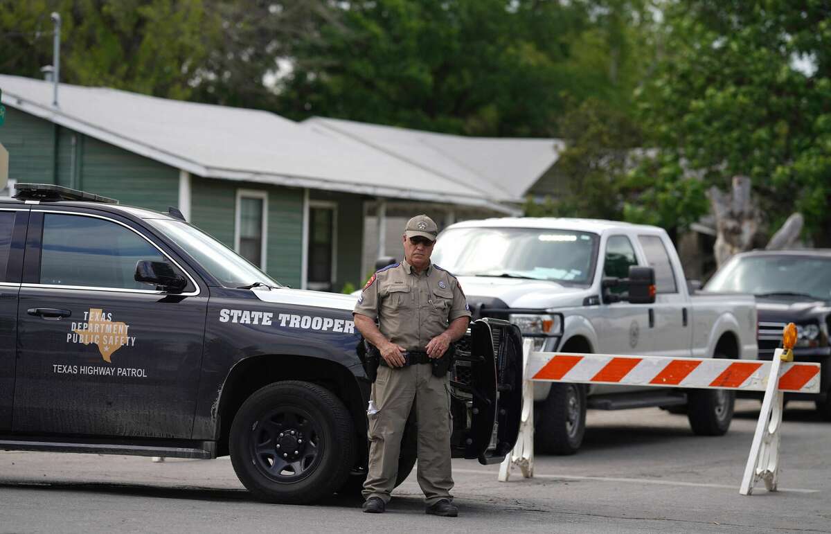 A State trooper stands seen outside of Robb Elementary School in Uvalde, Texas, on May 24, 2022. - An 18-year-old gunman killed 14 children and a teacher at an elementary school in Texas on Tuesday, according to the state's governor, in the nation's deadliest school shooting in years. (Photo by allison dinner / AFP) (Photo by ALLISON DINNER/AFP via Getty Images)