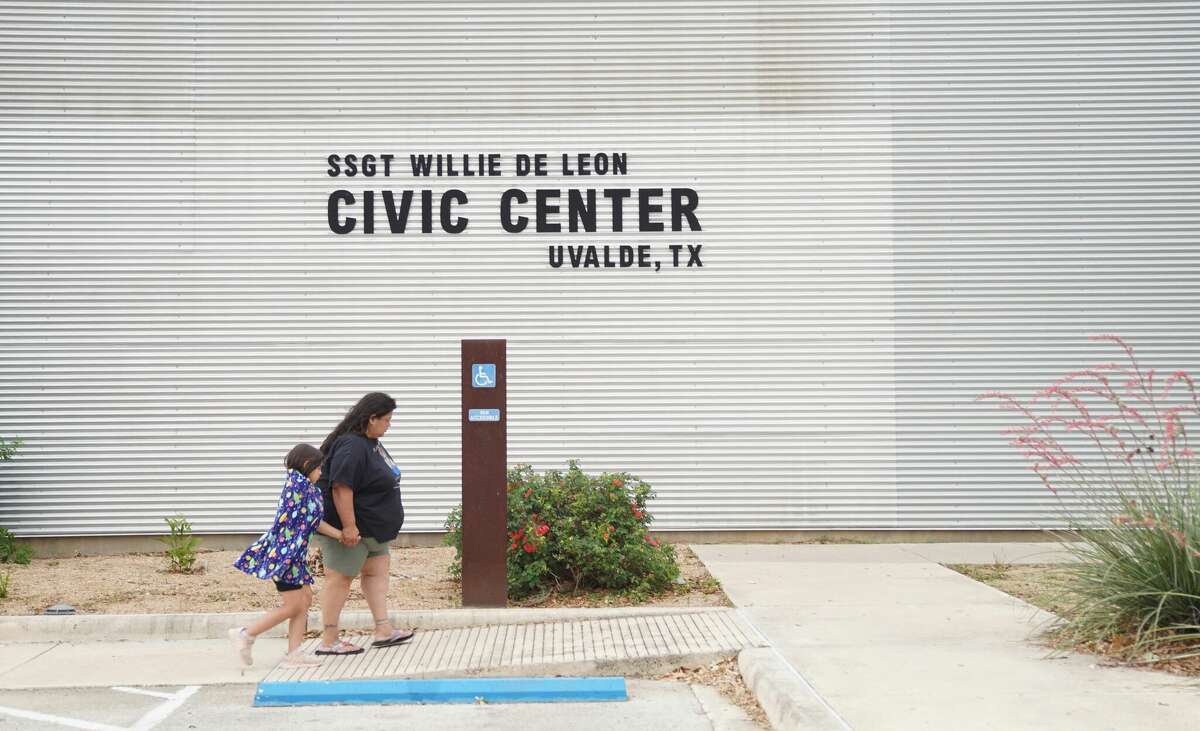 A woman and a young girl walk to the Willie de Leon Civic Center where grief counseling will be offered in Uvalde, Texas, on May 24, 2022. - A teenage gunman killed 18 young children in a shooting at an elementary school in Texas on Tuesday, in the deadliest US school shooting in years. The attack in Uvalde, Texas -- a small community about an hour from the Mexican border -- is the latest in a spree of deadly shootings in America, where horror at the cycle of gun violence has failed to spur action to end it. (Photo by allison dinner / AFP) (Photo by ALLISON DINNER/AFP via Getty Images)