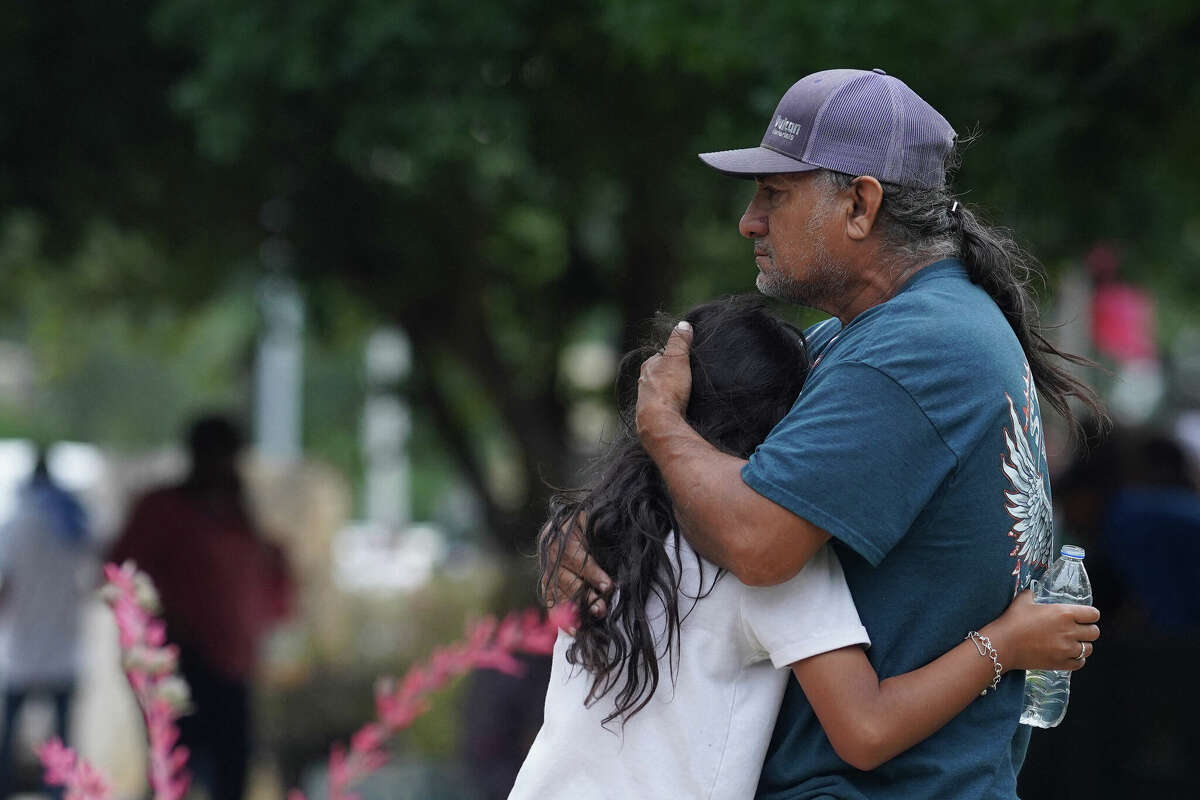 Families hug outside the Willie de Leon Civic Center where grief counseling will be offered in Uvalde, Texas, on May 24, 2022. - A teenage gunman killed 18 young children in a shooting at an elementary school in Texas on Tuesday, in the deadliest US school shooting in years. The attack in Uvalde, Texas -- a small community about an hour from the Mexican border -- is the latest in a spree of deadly shootings in America, where horror at the cycle of gun violence has failed to spur action to end it. (Photo by allison dinner / AFP) (Photo by ALLISON DINNER/AFP via Getty Images)
