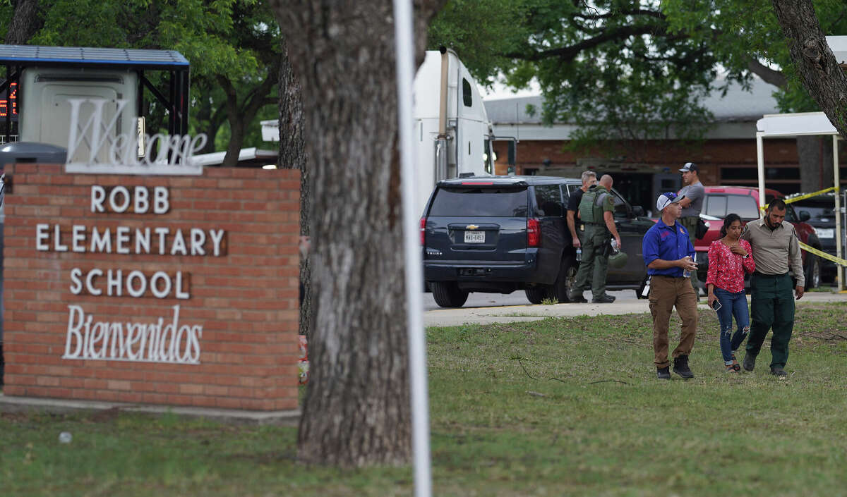 A welcome sign is seen outside of Robb Elementary School as people walk away in Uvalde, Texas, on May 24, 2022. - A teenage gunman killed 18 young children in a shooting at an elementary school in Texas on Tuesday, in the deadliest US school shooting in years. The attack in Uvalde, Texas -- a small community about an hour from the Mexican border -- is the latest in a spree of deadly shootings in America, where horror at the cycle of gun violence has failed to spur action to end it. (Photo by allison dinner / AFP) (Photo by ALLISON DINNER/AFP via Getty Images)