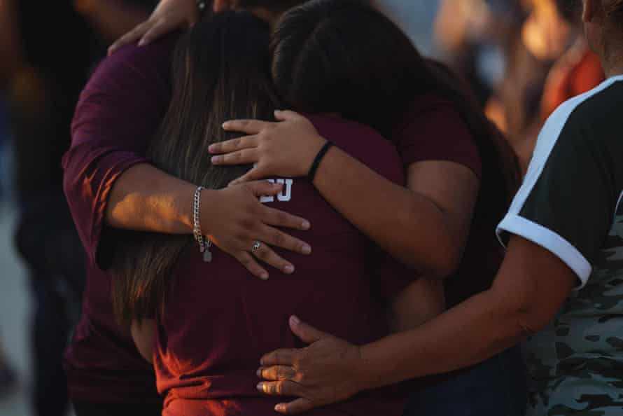 People mourn as they attend a vigil for the victims of the mass shooting at Robb Elementary School in Uvalde, Texas.