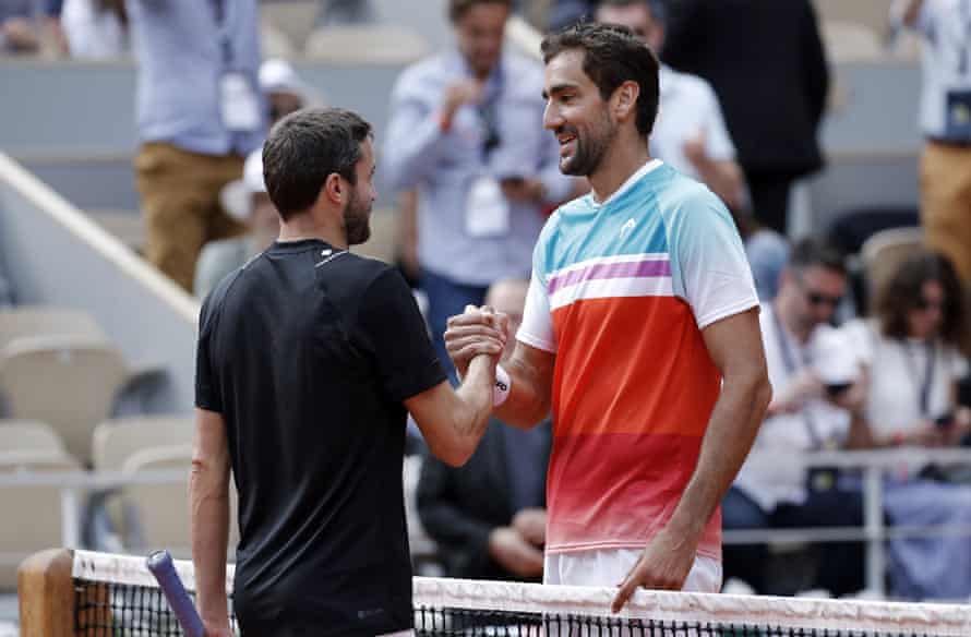 Marin Cilic (right) shakes hands with Gilles Simon .