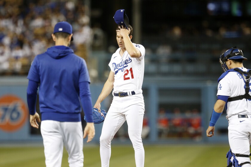 Dodgers pitching coach Mark Prior, left, visits starting pitcher Walker Buehler on the mound in the fourth inning Friday.