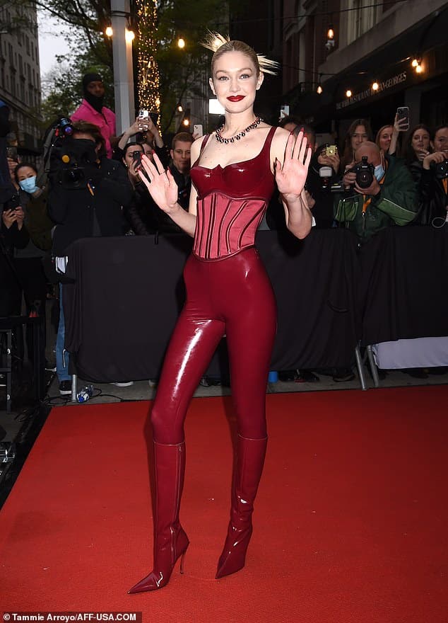 Striking: Gigi Hadid shows off her VERY trim frame and protruding hip bones in corseted PVC ensemble as she makes way to the Met Gala on Monday