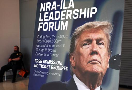A poster shows the face of former President Trump at the National Rifle Convention