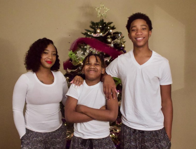 Adrian McDougles, center, with his mother, Kyneshia, and older brother, Ontario, in December 2020.