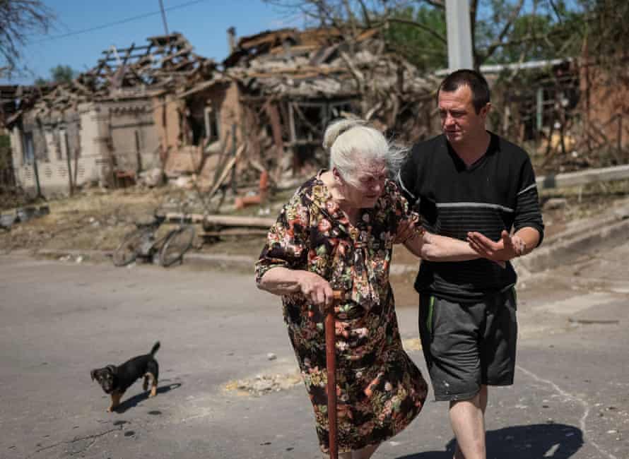 Elena, 81, leaves her building destroyed by a Russian military strike in the town of Druzhkivka, in Donetsk region, Ukraine, on Monday 6 June.