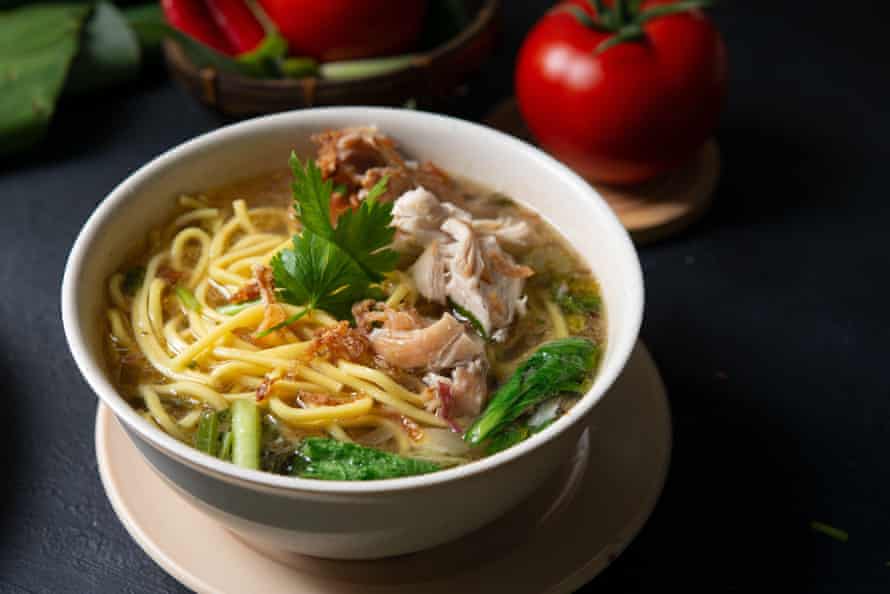 Chicken noodle soup with fresh and pickled Asian greens.