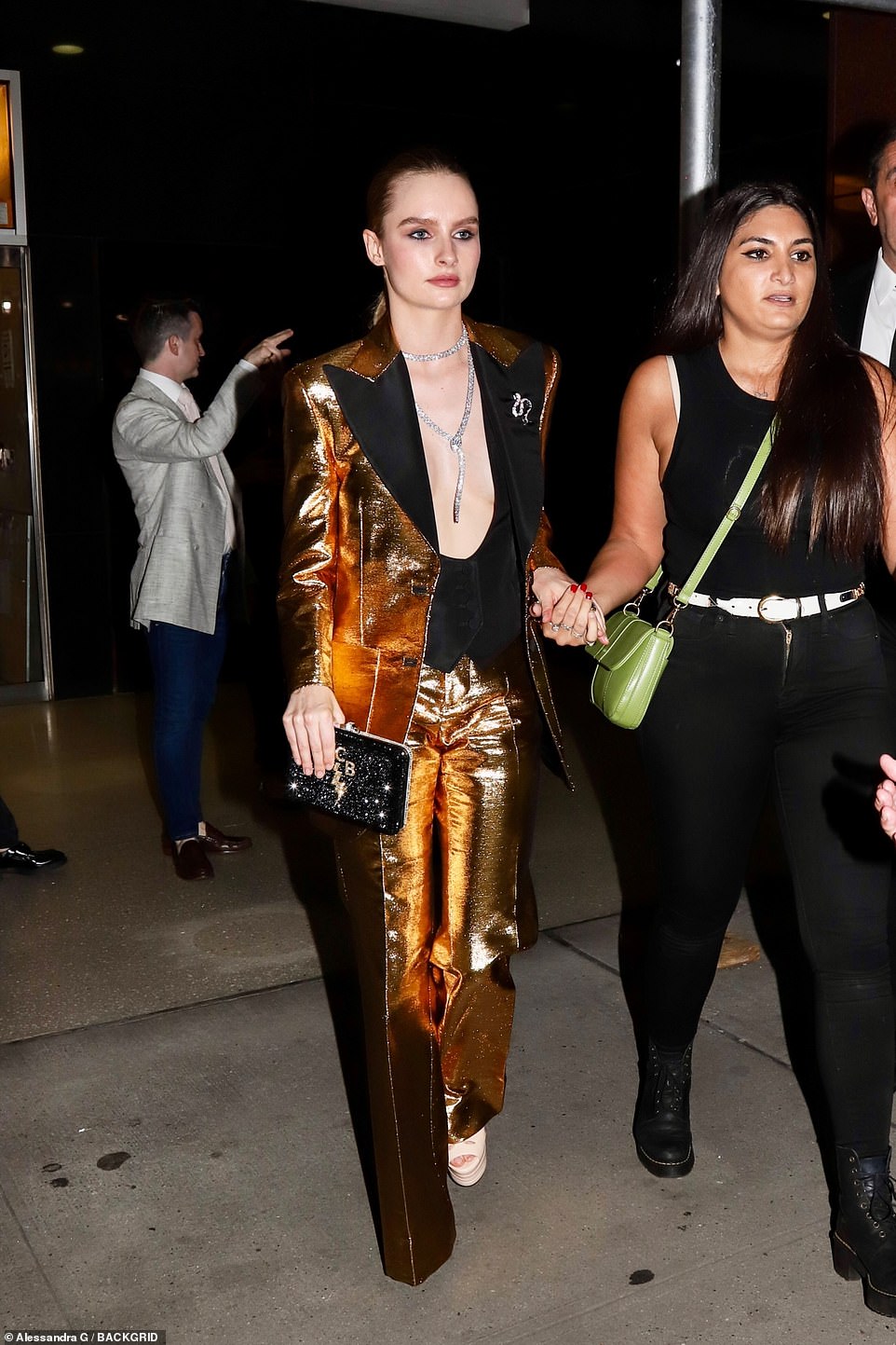 Golden girl: Actress Olivia DeJonge - who will appear onscreen as Elvis' ex-wife Priscilla Presley - stunned onlookers in a gleaming gold suit. The outfit choice was a clear nod to Presley's iconic gold lamé suit, which he'd worn on the cover of his LP '50,000,000 Elvis Fans Can’t Be Wrong' back in 1957