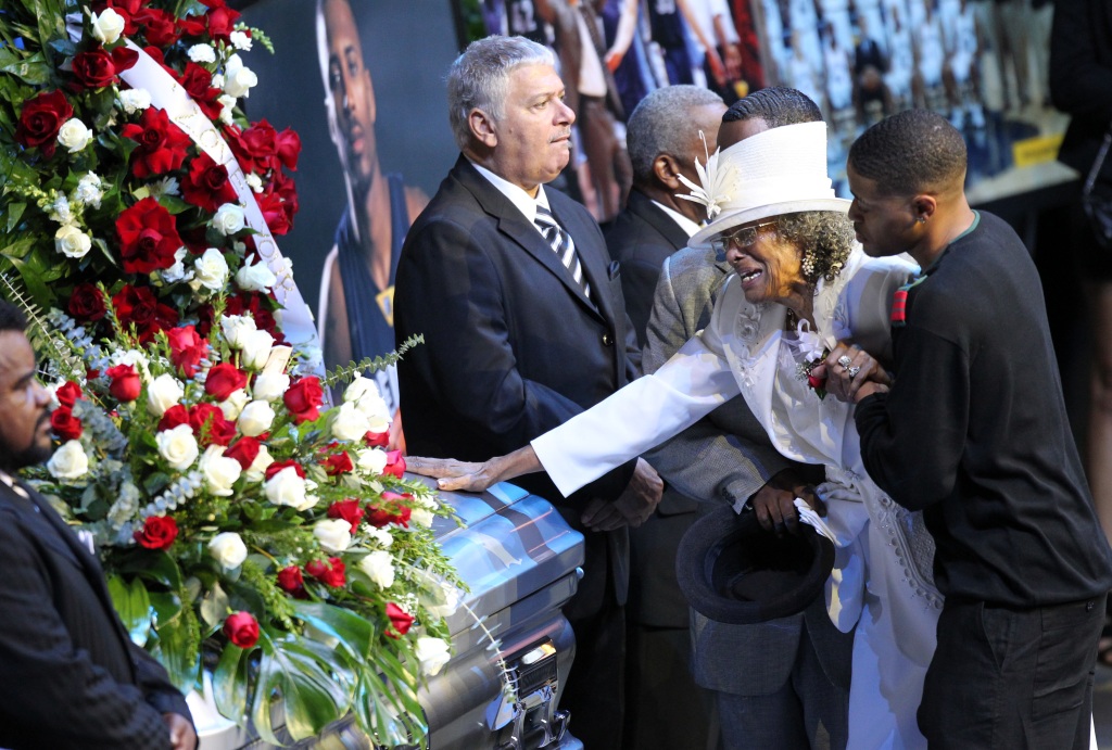 Louise Vassar, grandmother of Lorenzen Wright, mourns while touching the casket during his memorial service in Memphis.