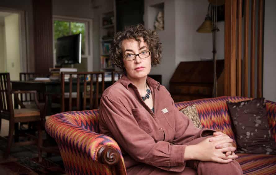Poet and writer Kate Clanchy sitting on a sofa at home in Oxford, Oct 2019