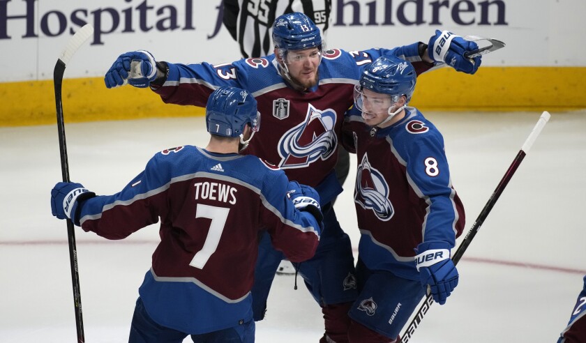 The Avalanche's Cale Makar, right, celebrates his goal with Valeri Nichushkin and Devon Toews on June 24, 2022.