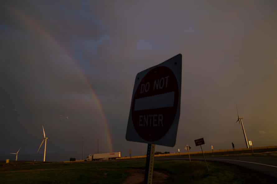 A rainbow over the freeway against dark clouds near Weatherford, Texas